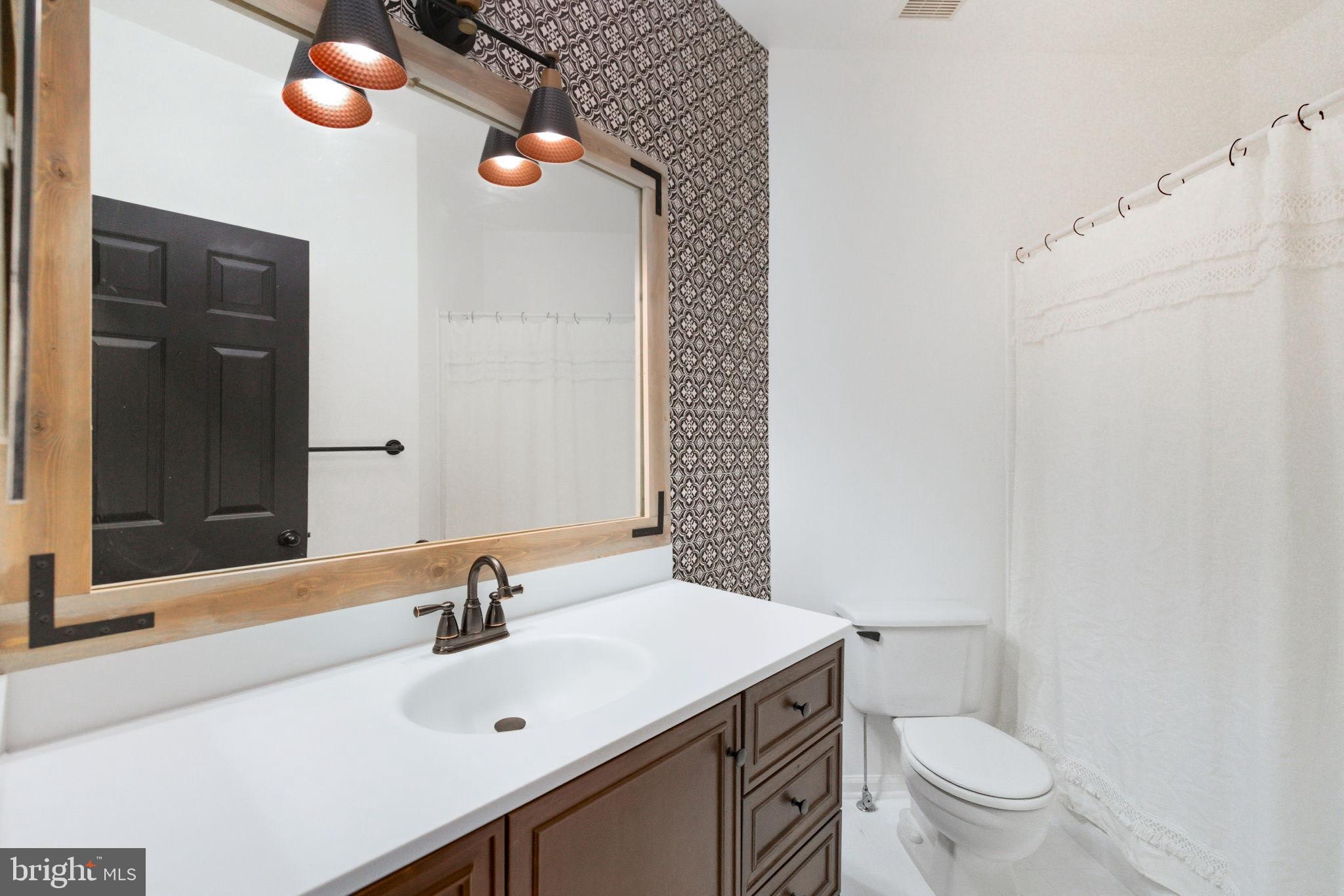20419 Riverbend Square, Unit 200 Sterling, VA 20165 - Photo 25 of 39 a bathroom with a sink a toilet and shower