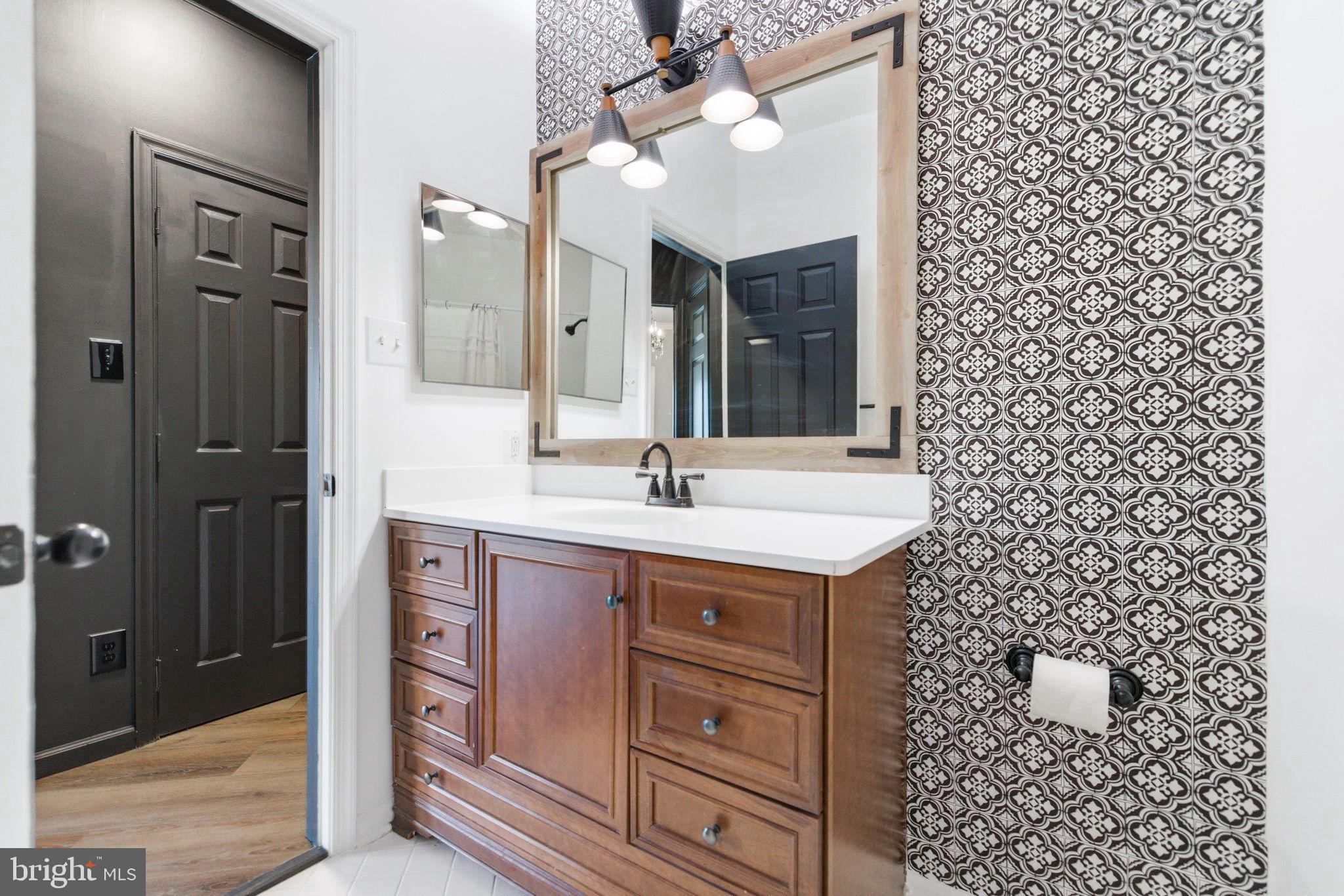 20419 Riverbend Square, Unit 200 Sterling, VA 20165 - Photo 27 of 39 a bathroom with a sink a vanity and a mirror