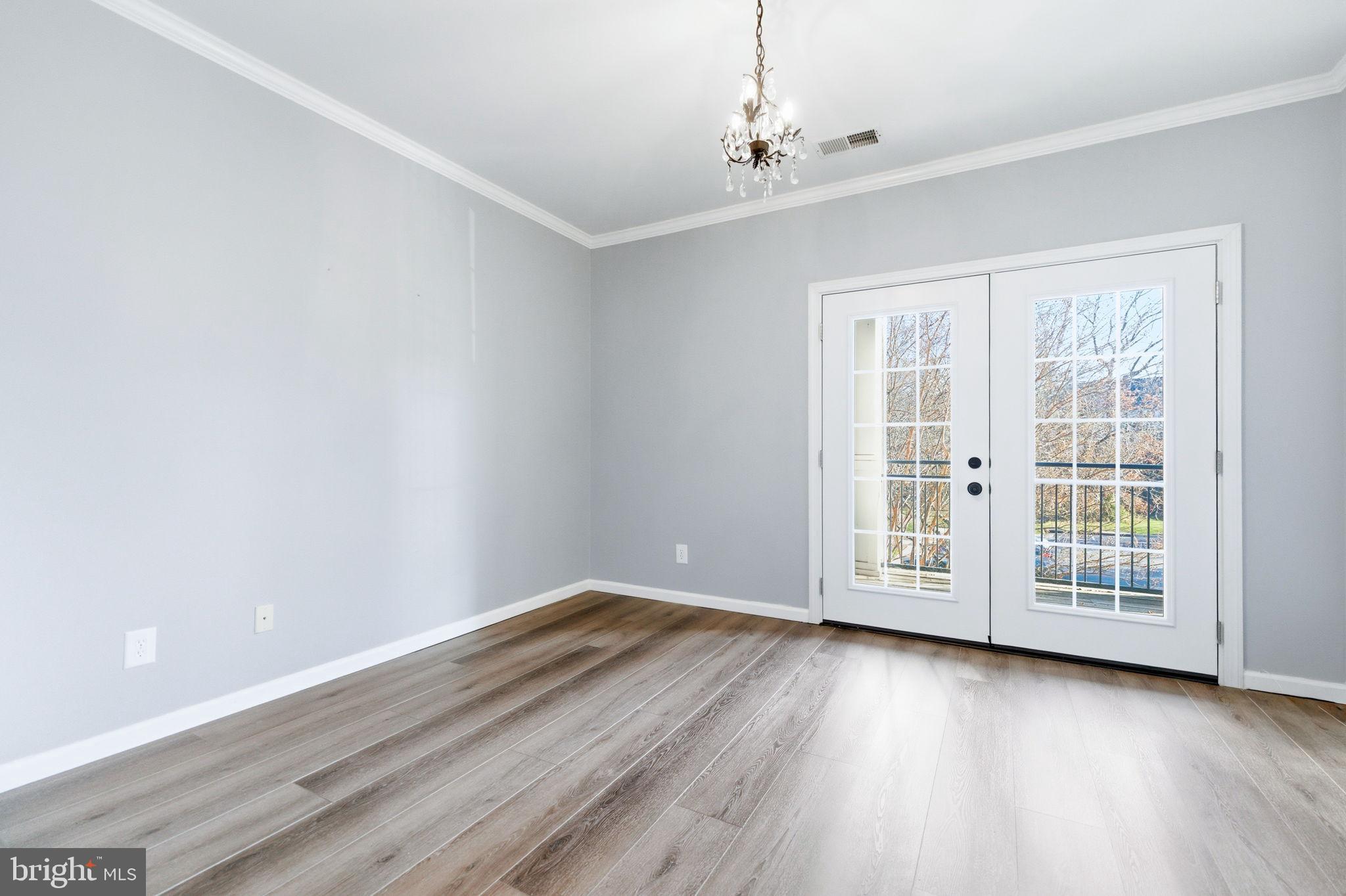 20419 Riverbend Square, Unit 200 Sterling, VA 20165 - Photo 28 of 39 wooden floor in an empty room with a window