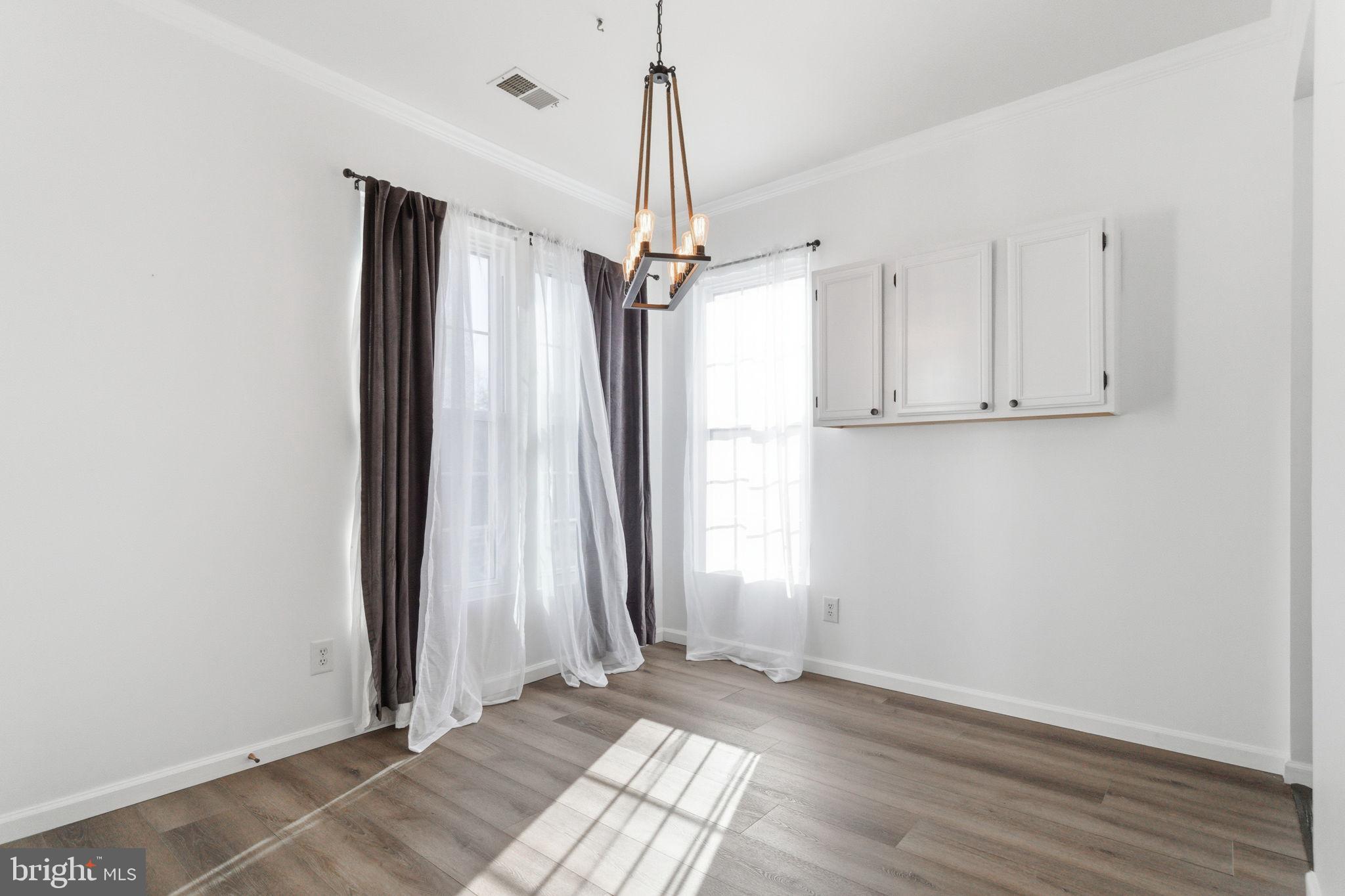 20419 Riverbend Square, Unit 200 Sterling, VA 20165 - Photo 35 of 39 wooden floor in an empty room with a window