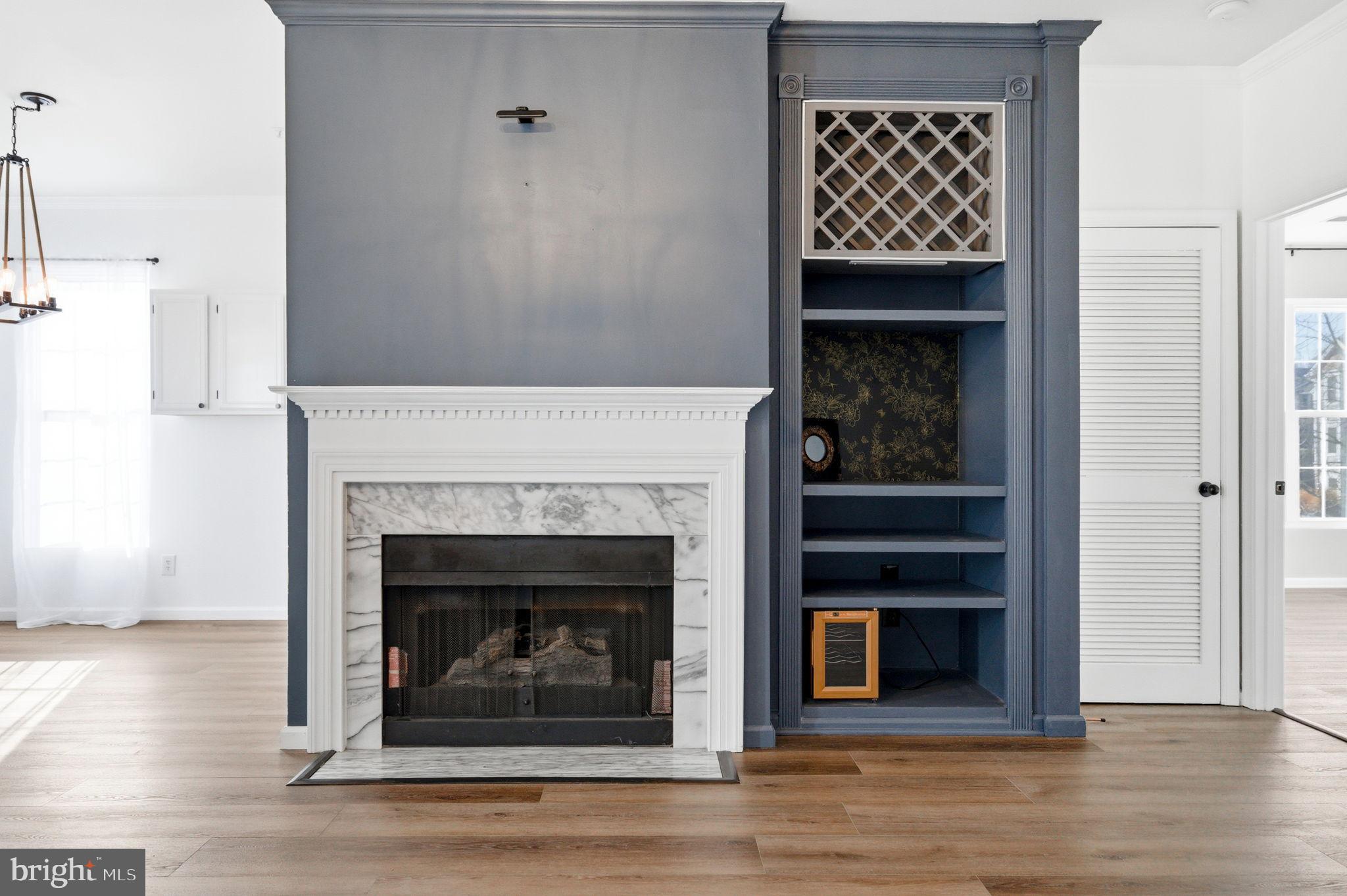 20419 Riverbend Square, Unit 200 Sterling, VA 20165 - Photo 36 of 39 a living room with wooden floor and a fireplace