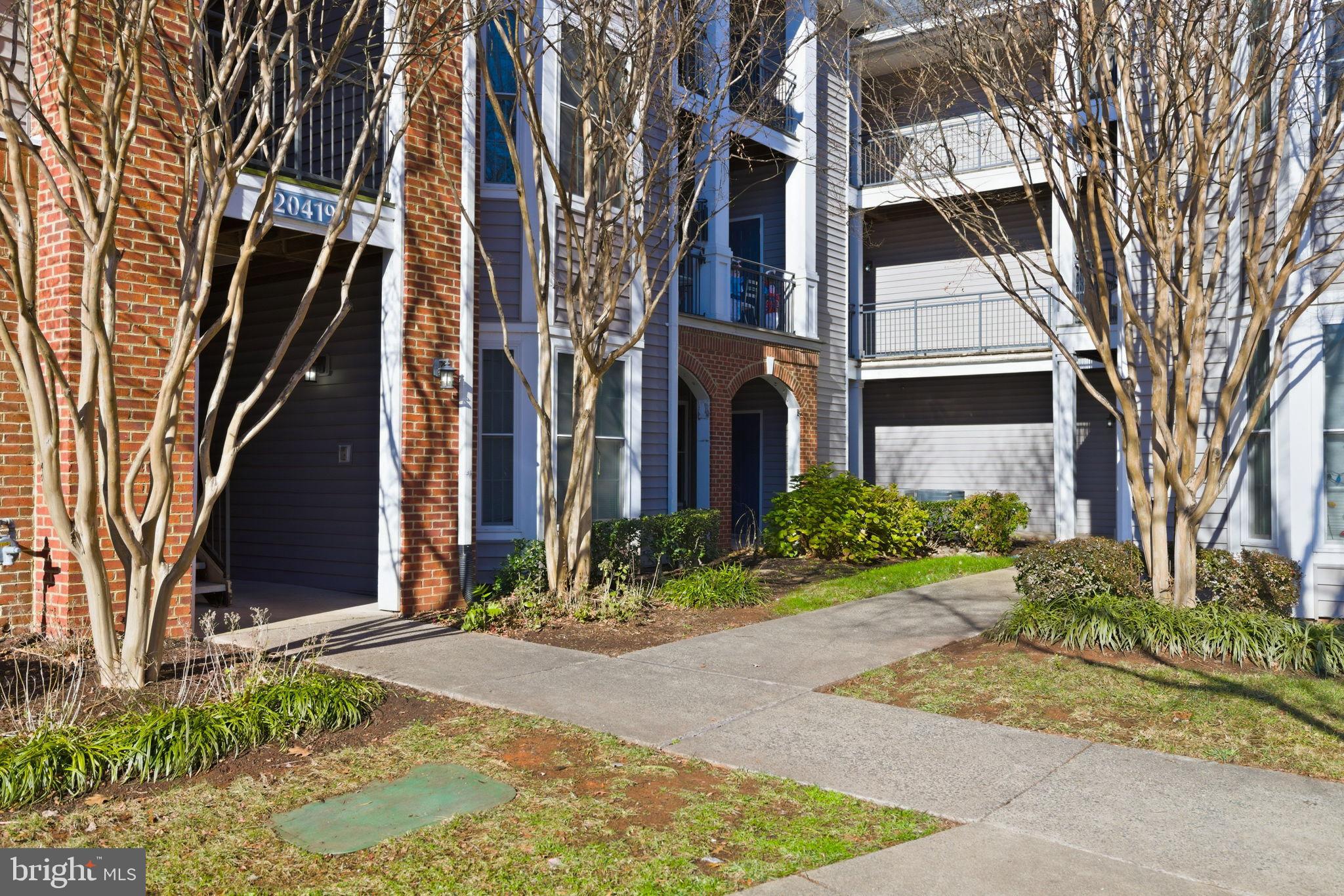 20419 Riverbend Square, Unit 200 Sterling, VA 20165 - Photo 38 of 39 a view of a building with a garden