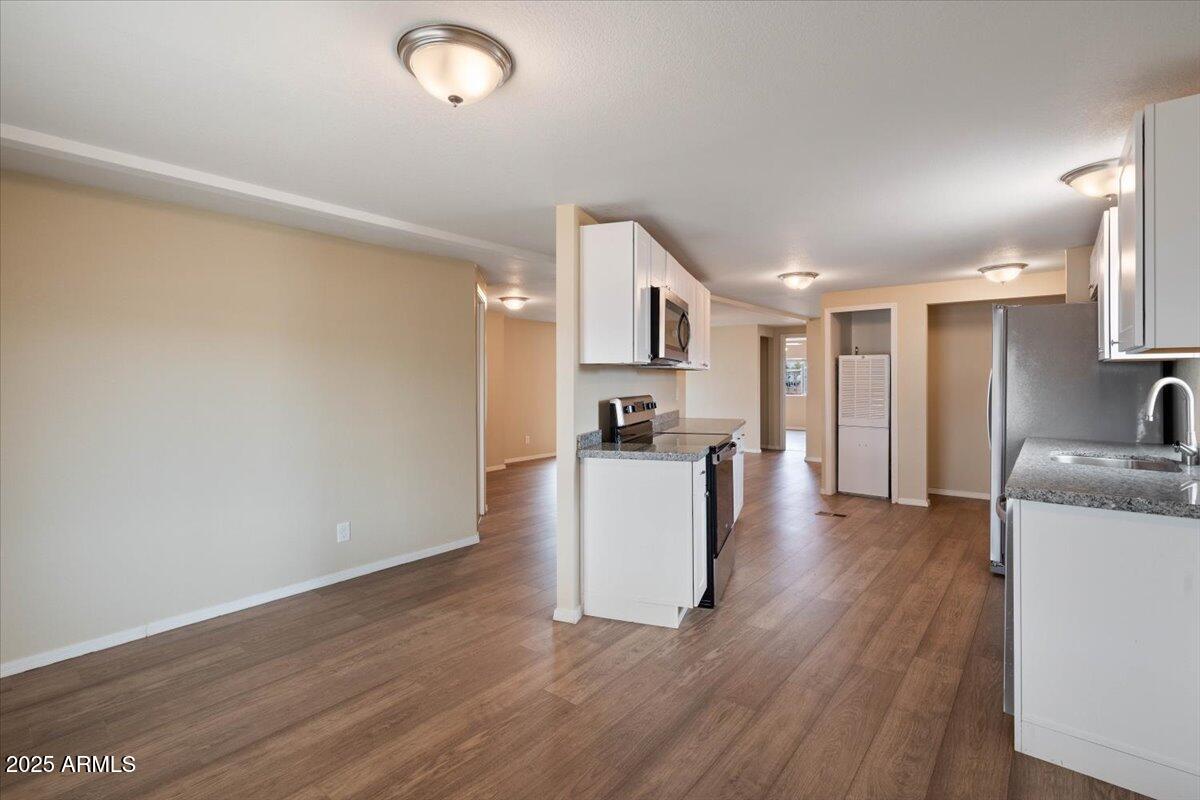 320 East McKellips Road, Unit 211 Mesa, AZ 85201 - Photo 15 of 27 a view of kitchen with furniture and wooden floor