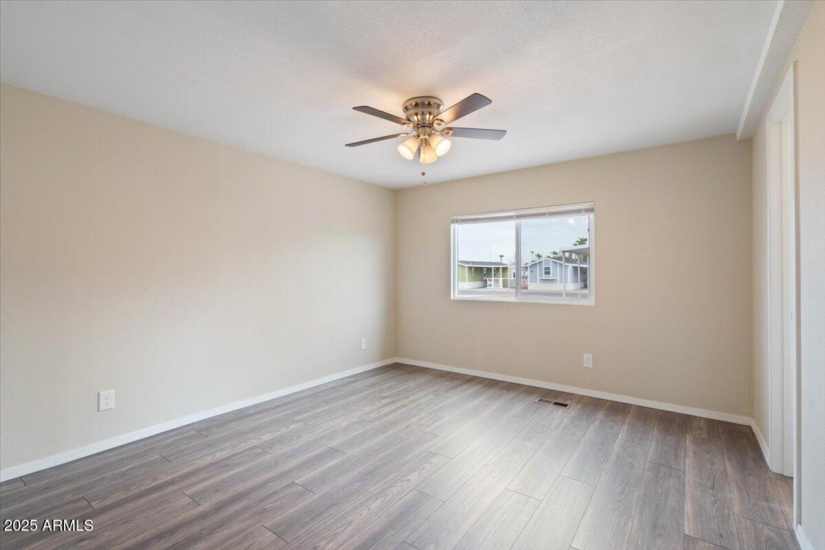 320 East McKellips Road, Unit 211 Mesa, AZ 85201 - Photo 17 of 27 wooden floor in an empty room with a window
