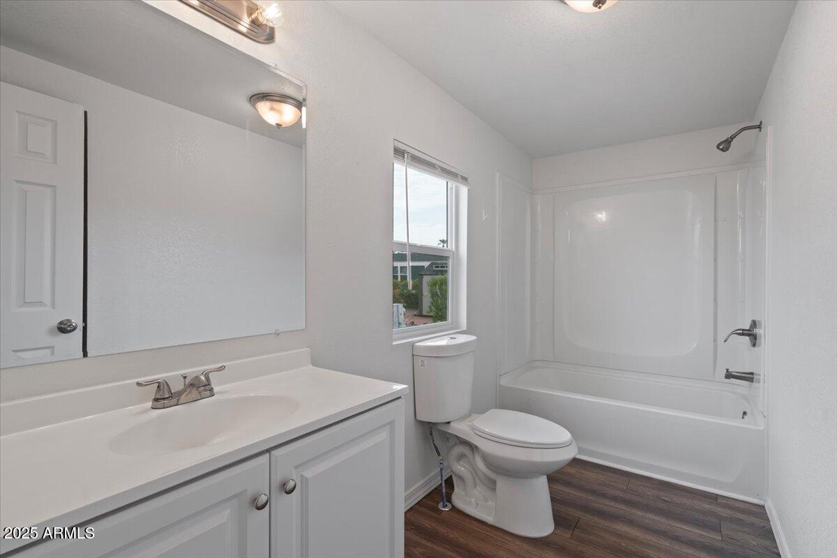 320 East McKellips Road, Unit 211 Mesa, AZ 85201 - Photo 19 of 27 a bathroom with a granite countertop sink toilet a large mirror and shower