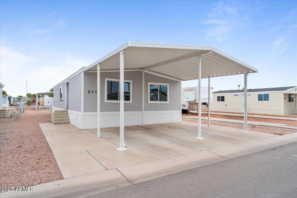 320 East McKellips Road, Unit 211 Mesa, AZ 85201 - Photo 6 of 27 a view of a white house with wooden floor