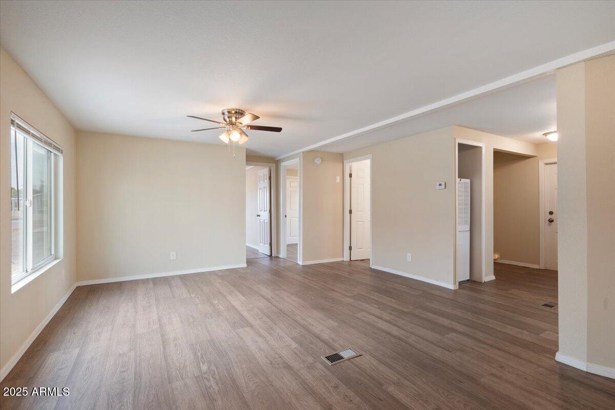 320 East McKellips Road, Unit 211 Mesa, AZ 85201 - Photo 8 of 27 a view of an empty room with a window and wooden floor