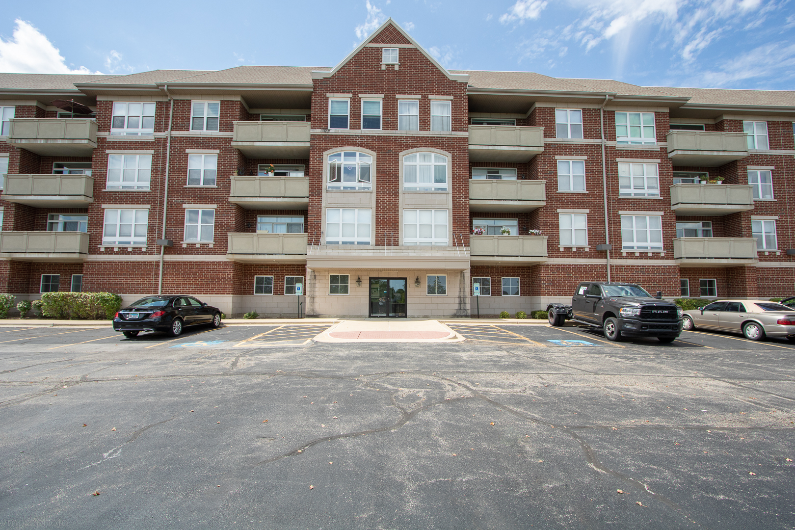 77 North Quentin Road, Unit 208 Palatine, IL 60067 - Photo 1 of 1 a view of a building with many windows