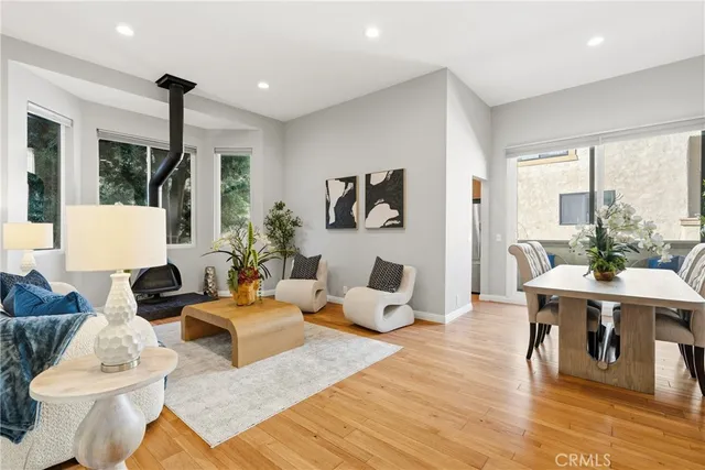 a living room with furniture large window and a table