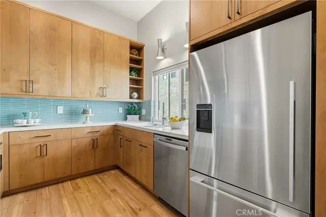 a kitchen with stainless steel appliances a refrigerator sink and cabinets