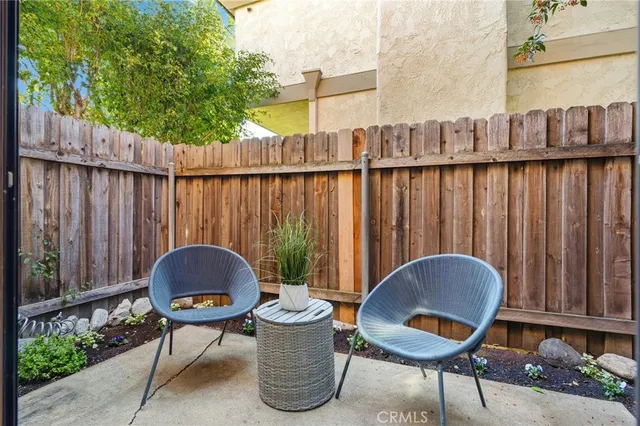 a backyard of a house with table and chairs
