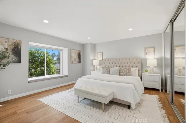 a spacious bedroom with a bed and a large window