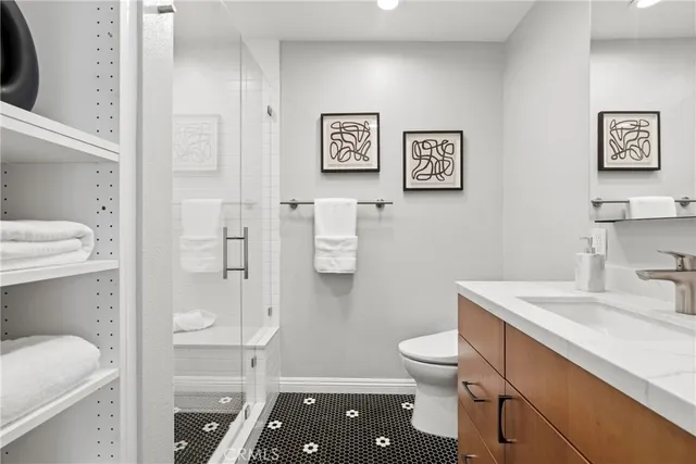 a bathroom with a granite countertop toilet sink and a mirror