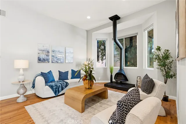 a living room with furniture lamp and a large window
