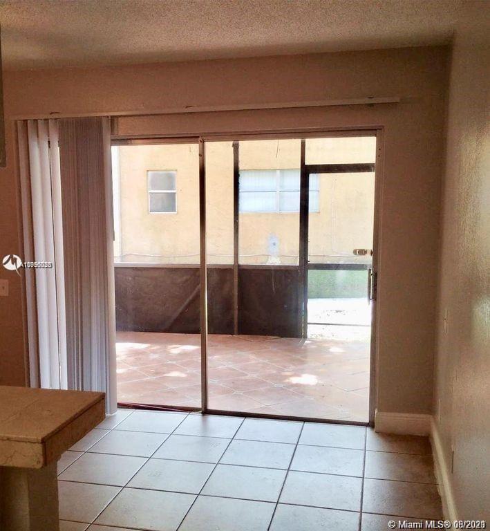 4537 Treehouse Lane, Unit C Tamarac, FL 33319 - Photo 5 of 11 a view of an empty room and window