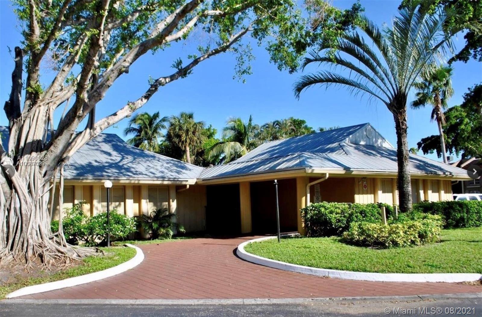 4537 Treehouse Lane, Unit C Tamarac, FL 33319 - Photo 9 of 11 a front view of a house with garden