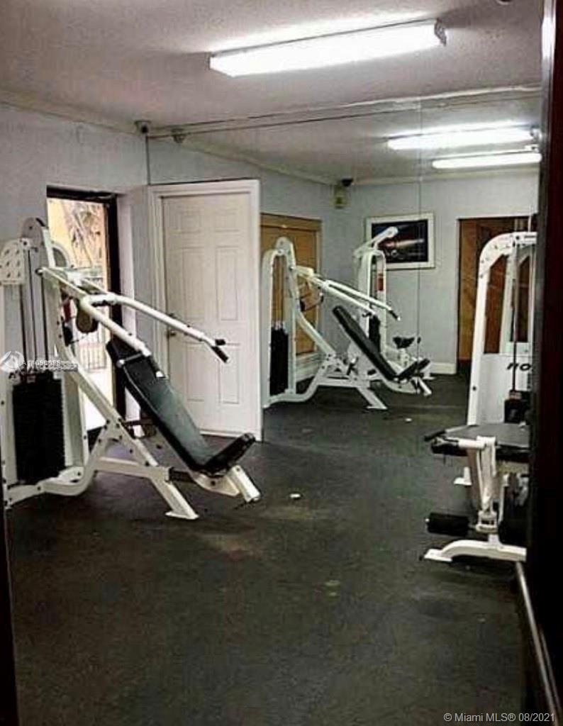 4537 Treehouse Lane, Unit C Tamarac, FL 33319 - Photo 10 of 11 a view of a room with gym equipment