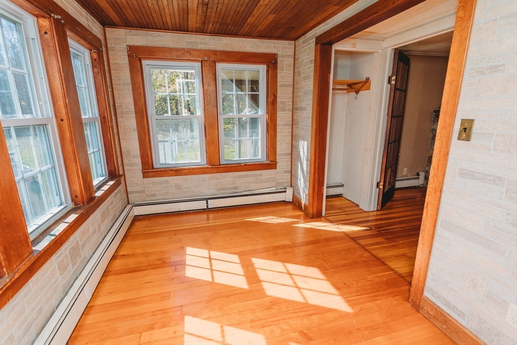 163 Hazelton Road Rowe, MA 01367 - Photo 12 of 40 a view of an empty room with wooden floor and a window