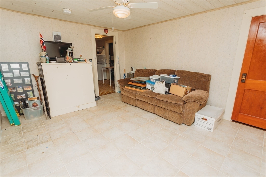 163 Hazelton Road Rowe, MA 01367 - Photo 19 of 40 a living room with furniture and a refrigerator