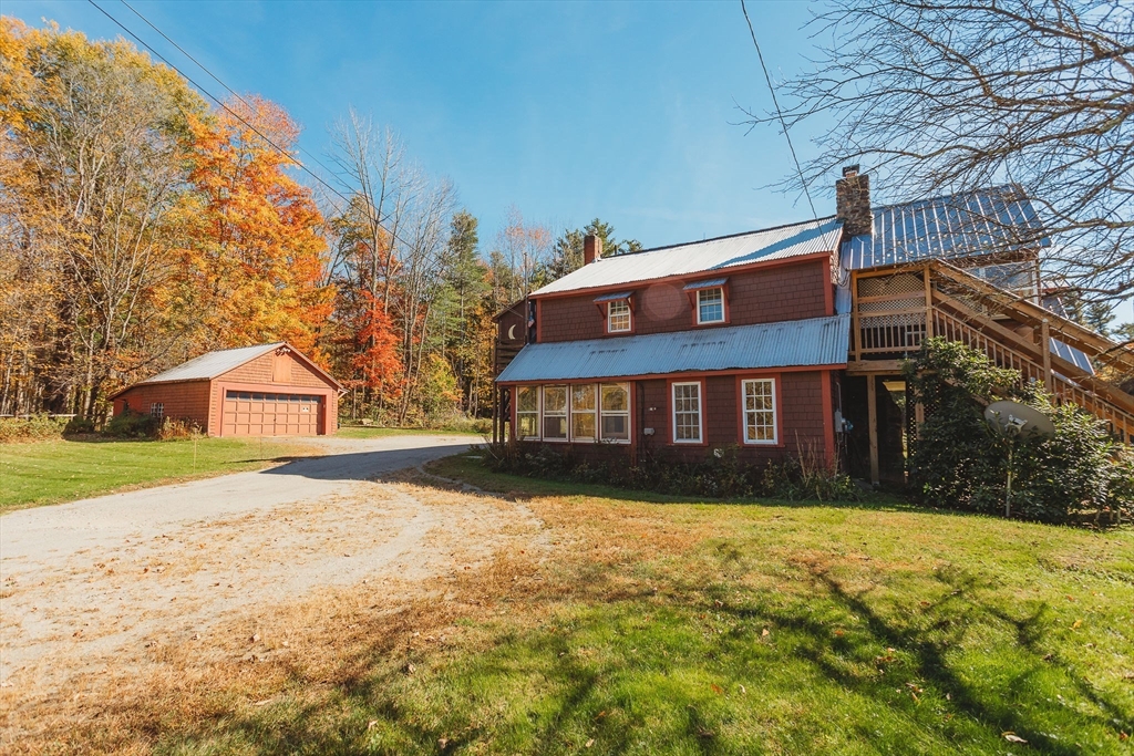 163 Hazelton Road Rowe, MA 01367 - Photo 2 of 40 a view of house with yard and trees in the background