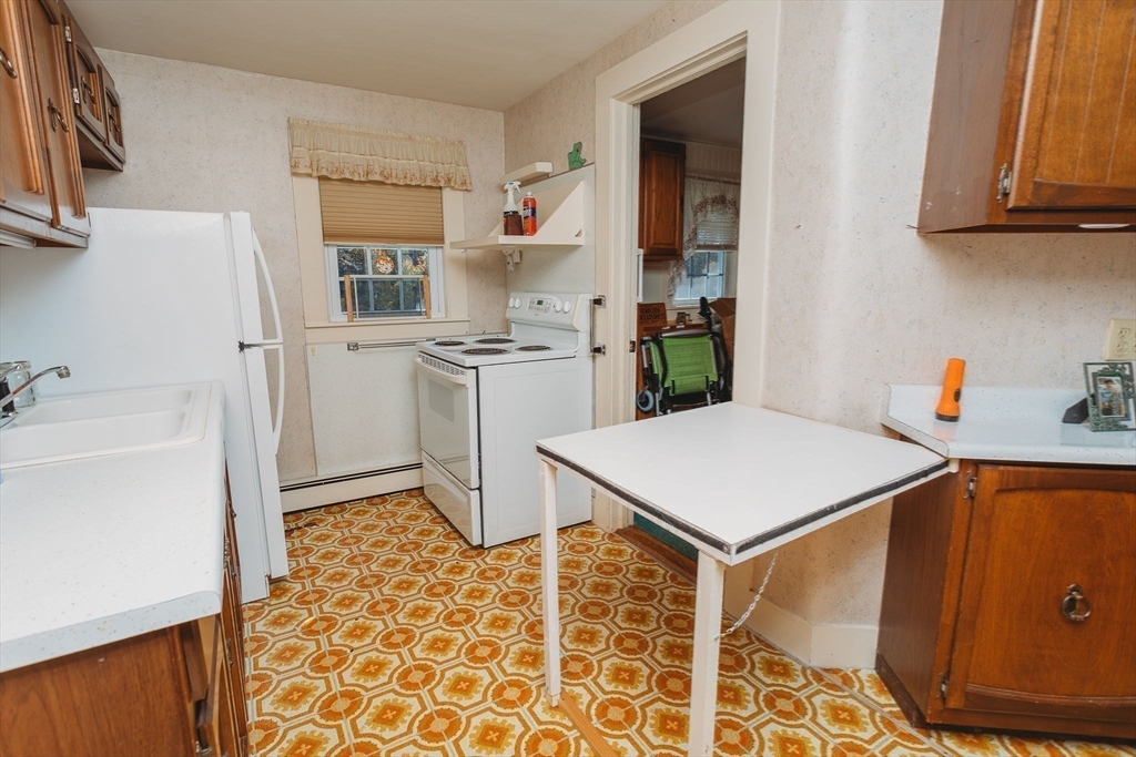 163 Hazelton Road Rowe, MA 01367 - Photo 21 of 40 a kitchen with a sink a stove and refrigerator