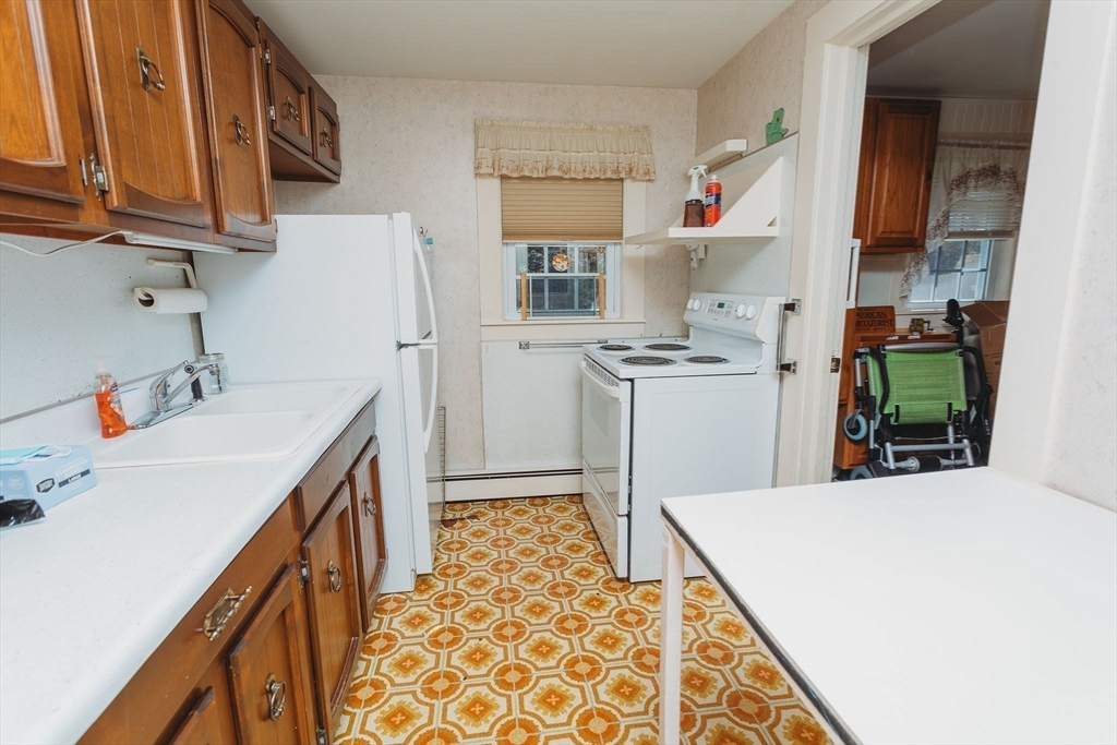 163 Hazelton Road Rowe, MA 01367 - Photo 23 of 40 a kitchen with a sink a stove and cabinets