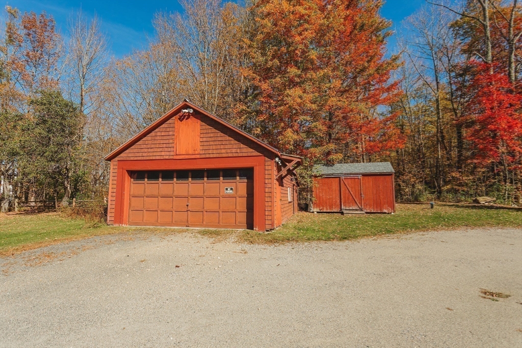 163 Hazelton Road Rowe, MA 01367 - Photo 40 of 40 a front view of a house with a yard and garage