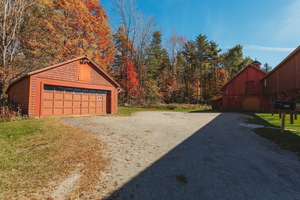 163 Hazelton Road Rowe, MA 01367 - Photo 5 of 40 a front view of a house with a yard and garage