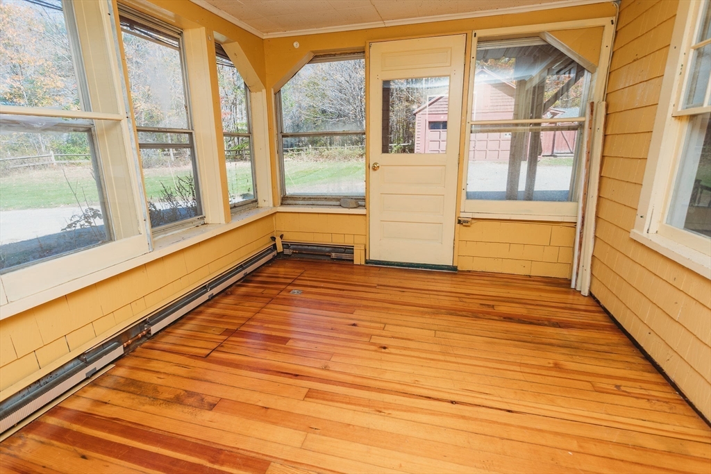 163 Hazelton Road Rowe, MA 01367 - Photo 7 of 40 a view of an empty room with wooden floor and a window