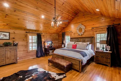 a bedroom with a bed and a chandelier