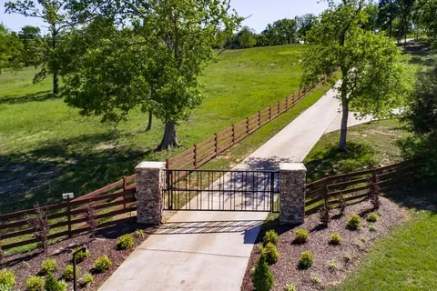 a backyard of a house with lots of green space and outdoor seating