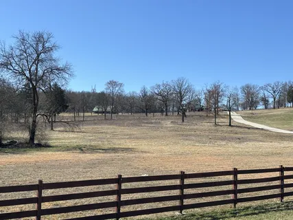 a view of room with wooden floor and outdoor seating
