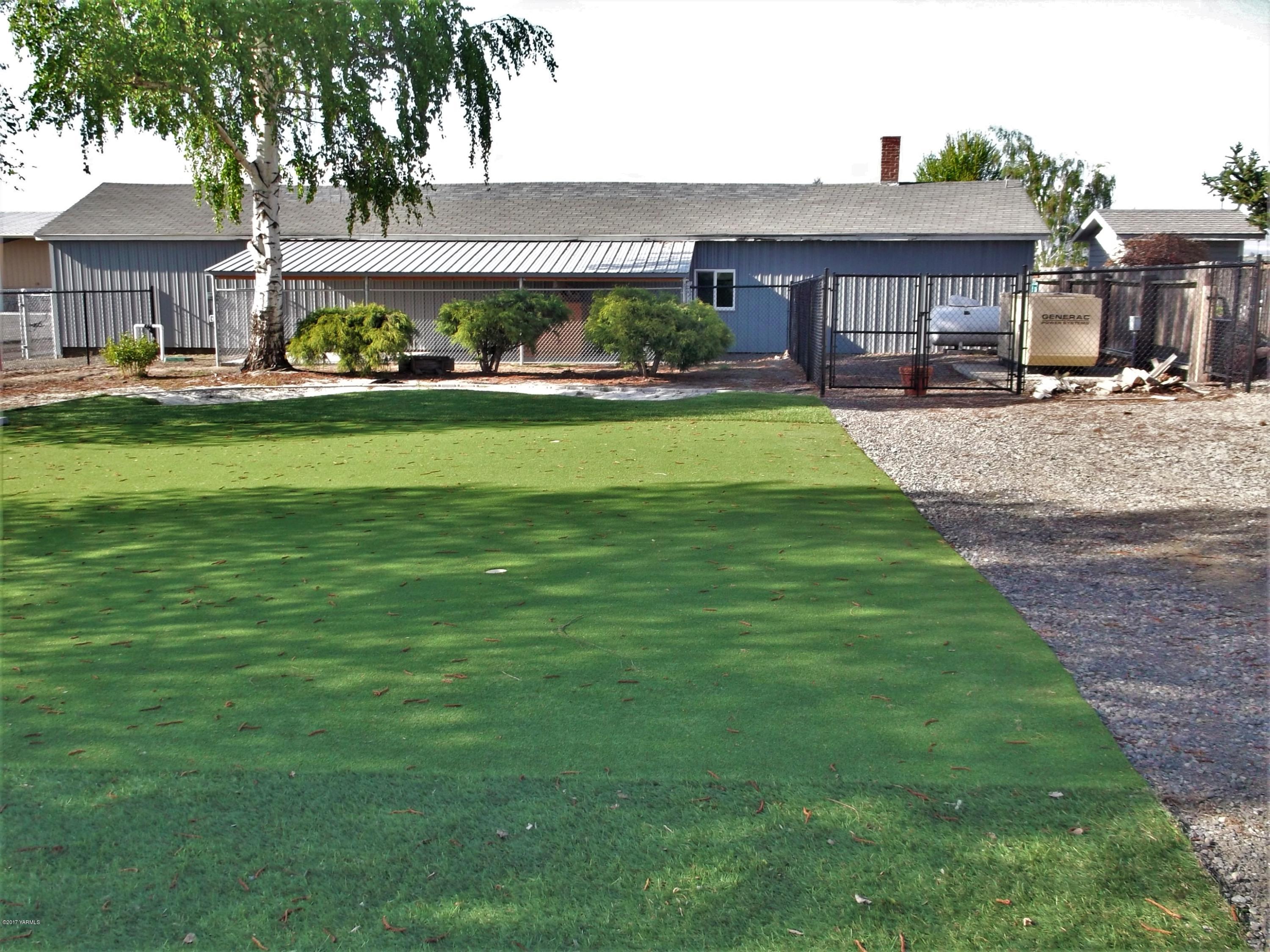 2000 Hornby Road Grandview, WA 98930 - Photo 19 of 45 a front view of a house with a yard table and chairs