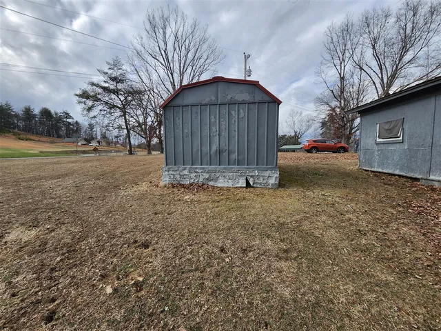 a small garden covered with wooden fence