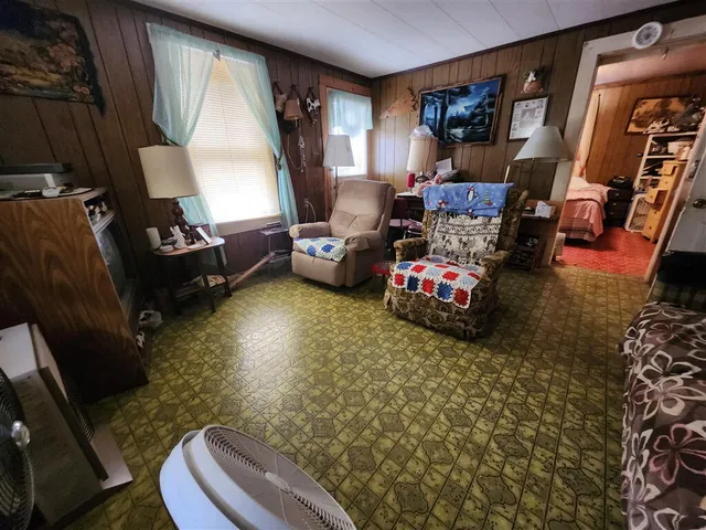 a bedroom with furniture and a large window