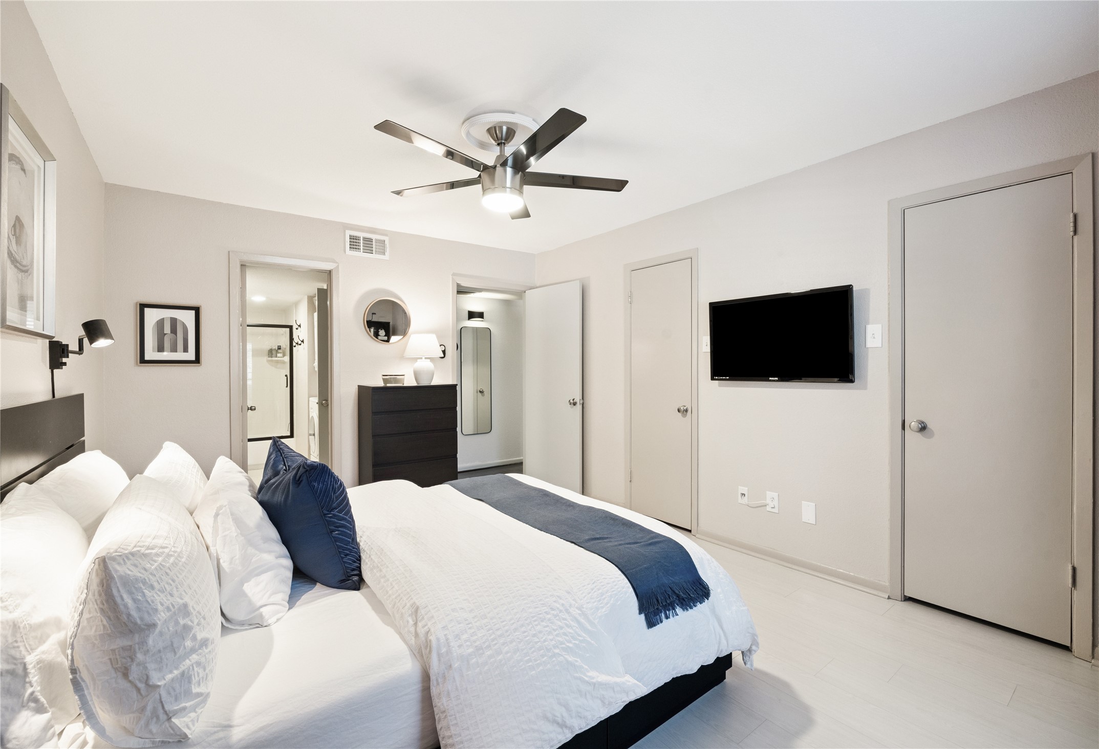 7555 Katy Freeway, Unit 50 Houston, TX 77024 - Photo 11 of 13 a bedroom with a bed and a flat screen tv