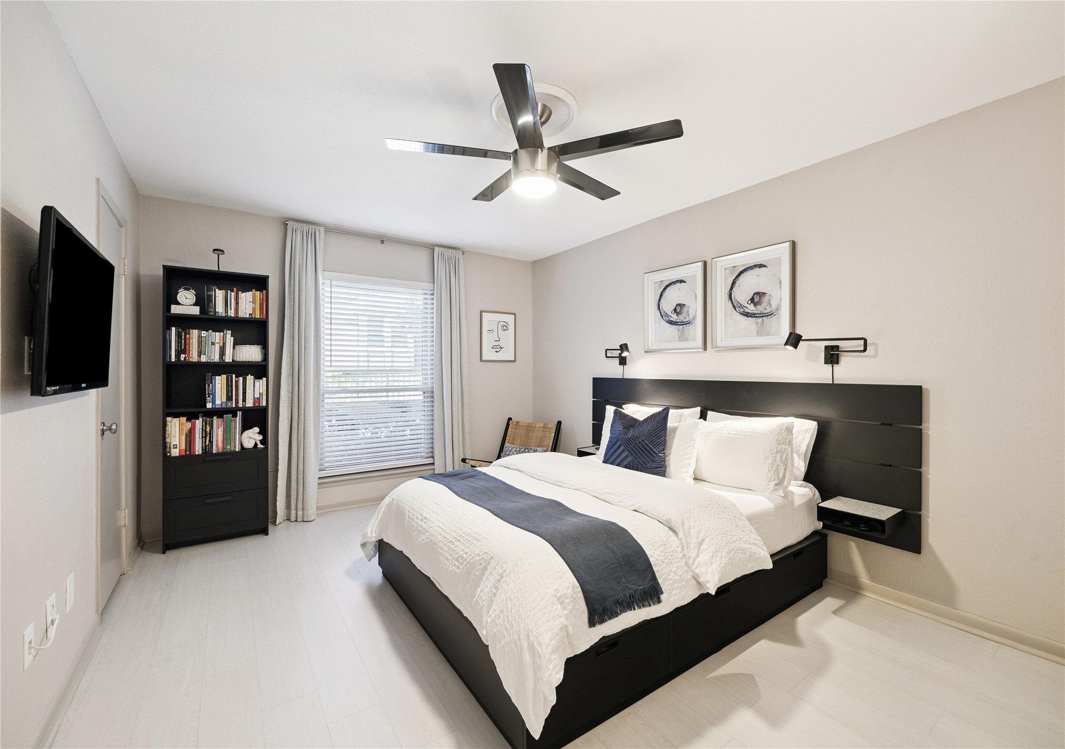 7555 Katy Freeway, Unit 50 Houston, TX 77024 - Photo 10 of 13 a bedroom with a large bed and a tv