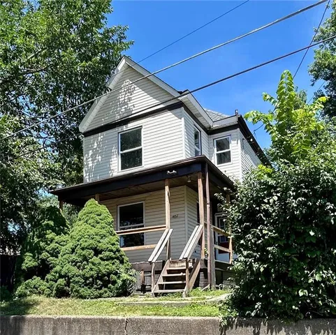 a house that has a tree in front of the house