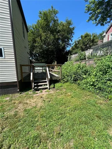 a backyard of a house with outdoor seating and trees