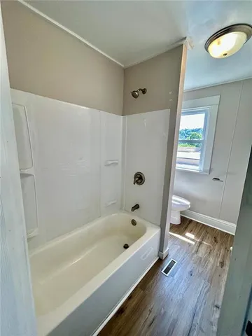 a bathroom with a bathtub and a shower