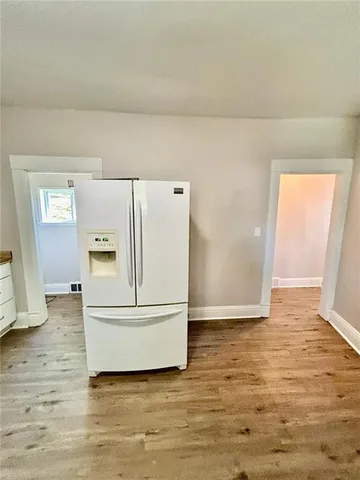 a view of kitchen and wooden floor