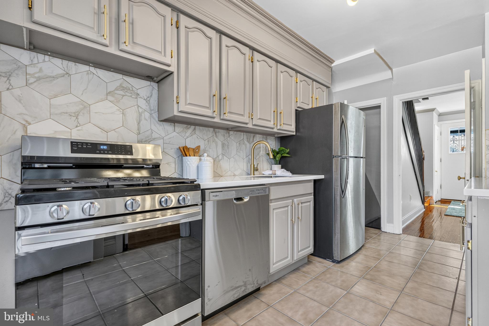 3906 Yolando Road Baltimore, MD 21218 - Photo 7 of 30 a kitchen with stainless steel appliances granite countertop a refrigerator and a stove