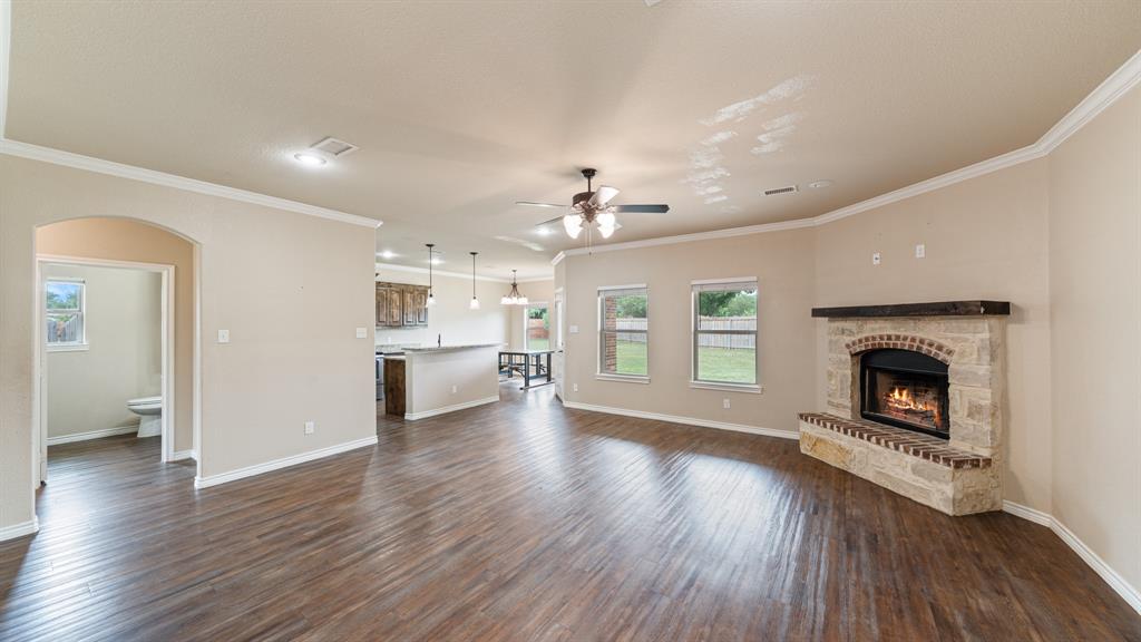 1401 Ridgebriar Drive Kaufman, TX 75142 - Photo 3 of 26 Open concept living room and kitchen feature vinyl flooring and fireplace