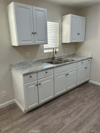 a kitchen with white cabinets white cabinets and a sink