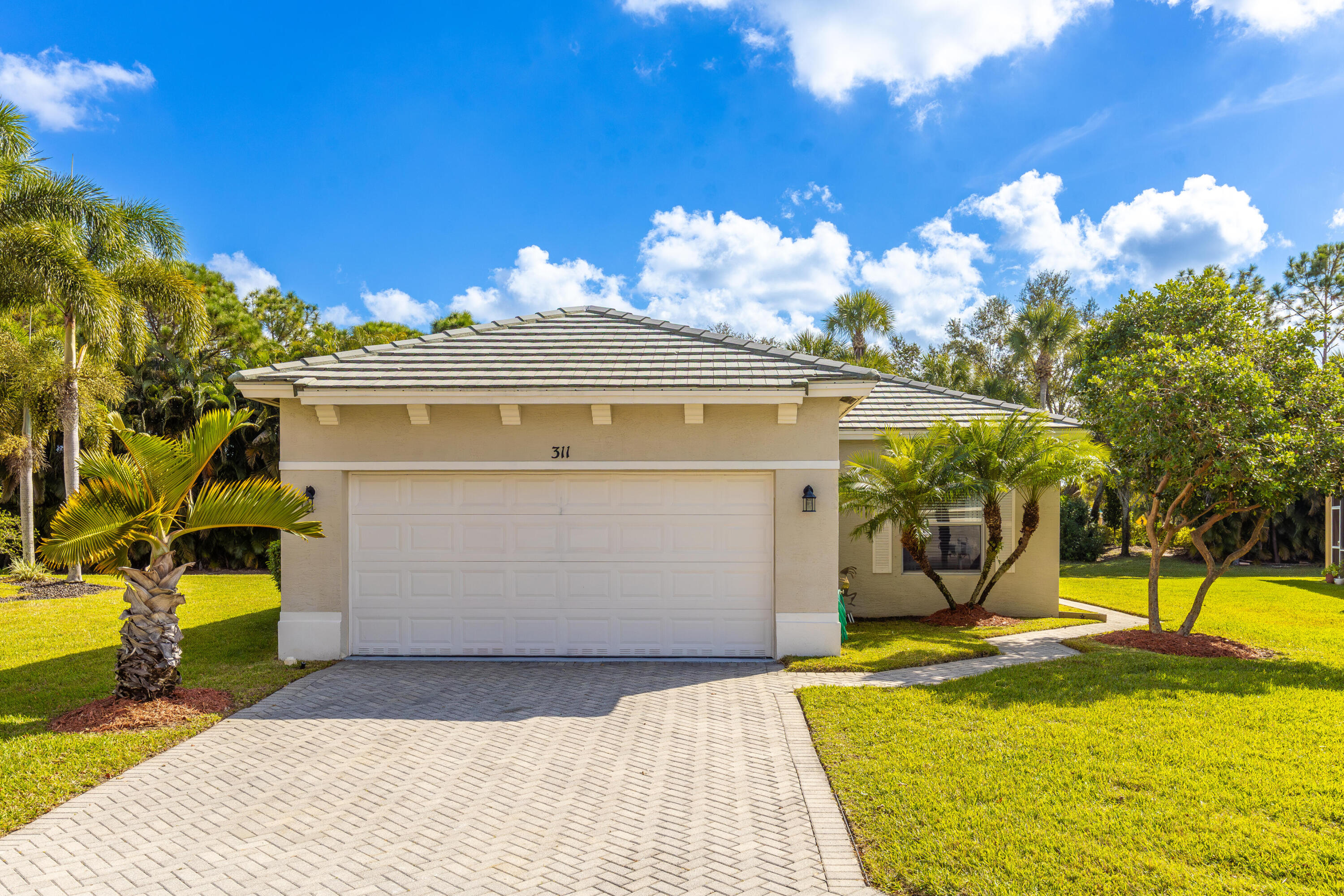 311 Southwest Coconut Key Way Port St. Lucie, FL 34986 - Photo 1 of 25 a view of a house with a backyard