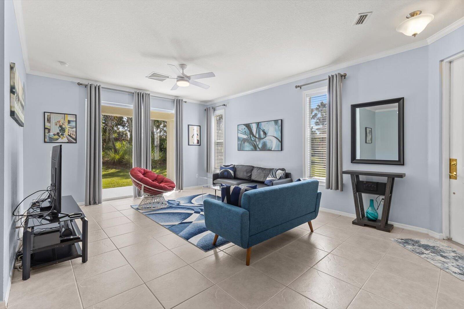 311 Southwest Coconut Key Way Port St. Lucie, FL 34986 - Photo 13 of 25 a living room with furniture and a flat screen tv