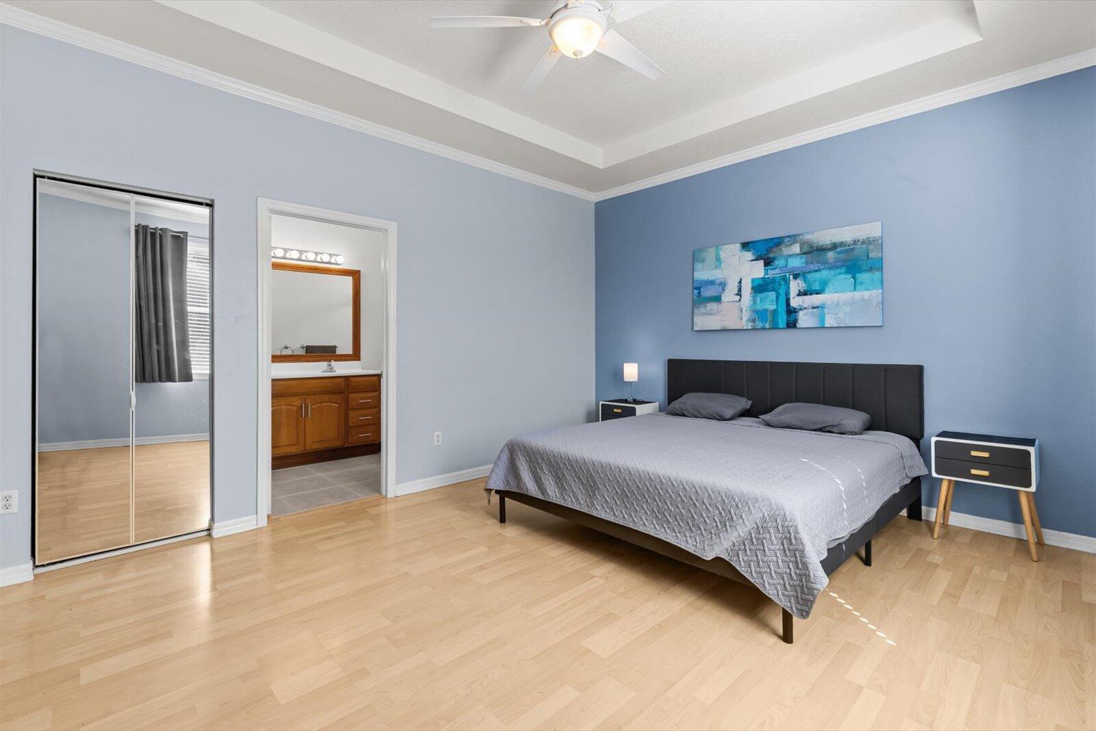 311 Southwest Coconut Key Way Port St. Lucie, FL 34986 - Photo 15 of 25 a bedroom with a bed and a chandelier