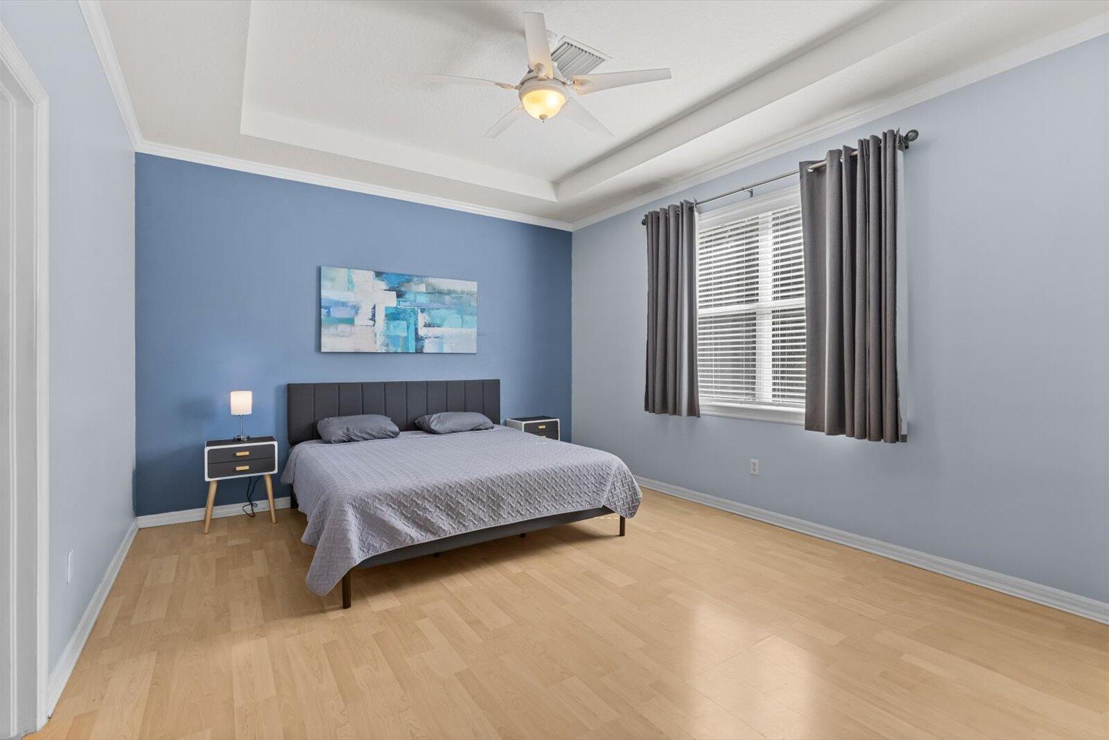 311 Southwest Coconut Key Way Port St. Lucie, FL 34986 - Photo 16 of 25 a bedroom with a bed dresser and a window