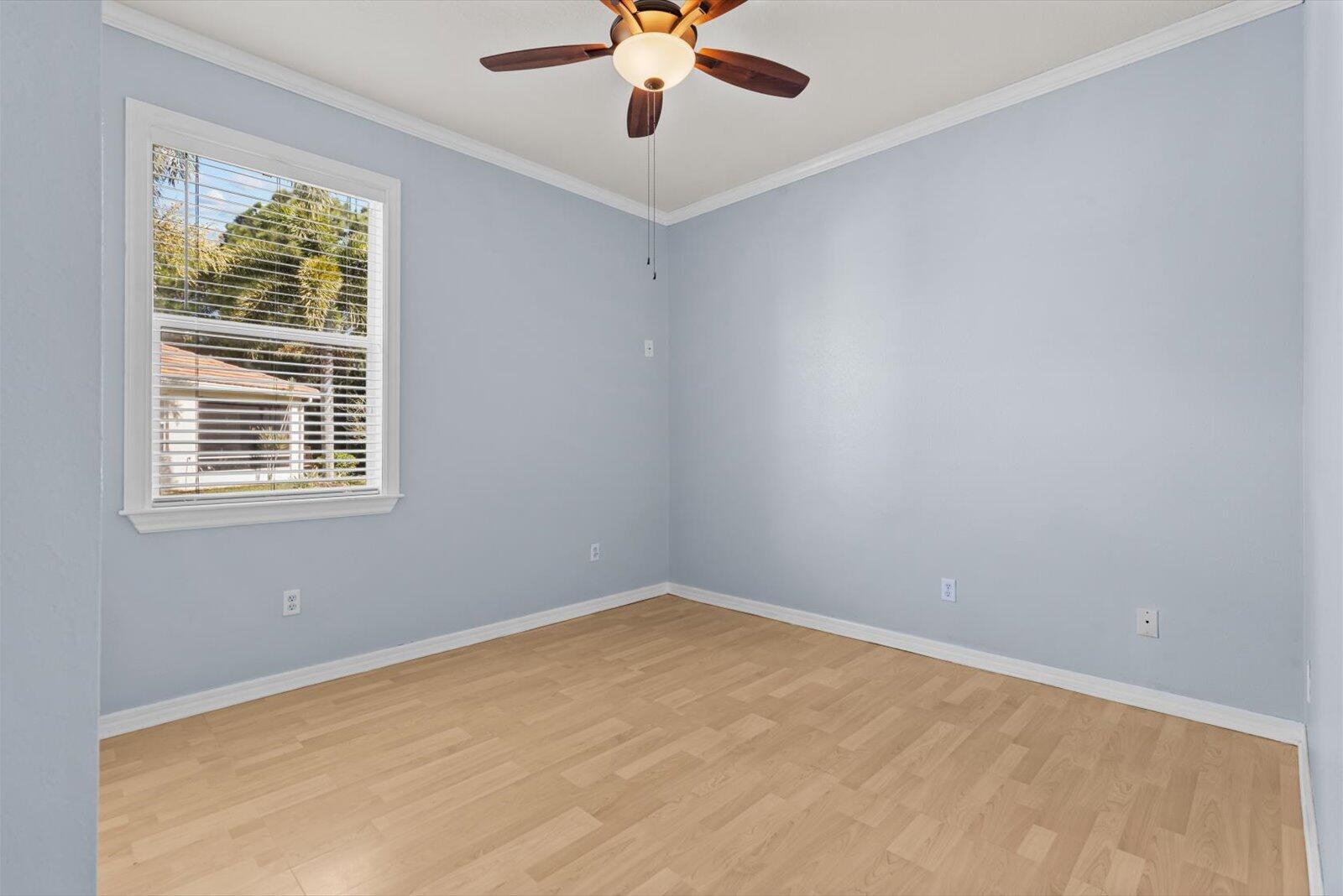 311 Southwest Coconut Key Way Port St. Lucie, FL 34986 - Photo 17 of 25 an empty room with a window and a fan