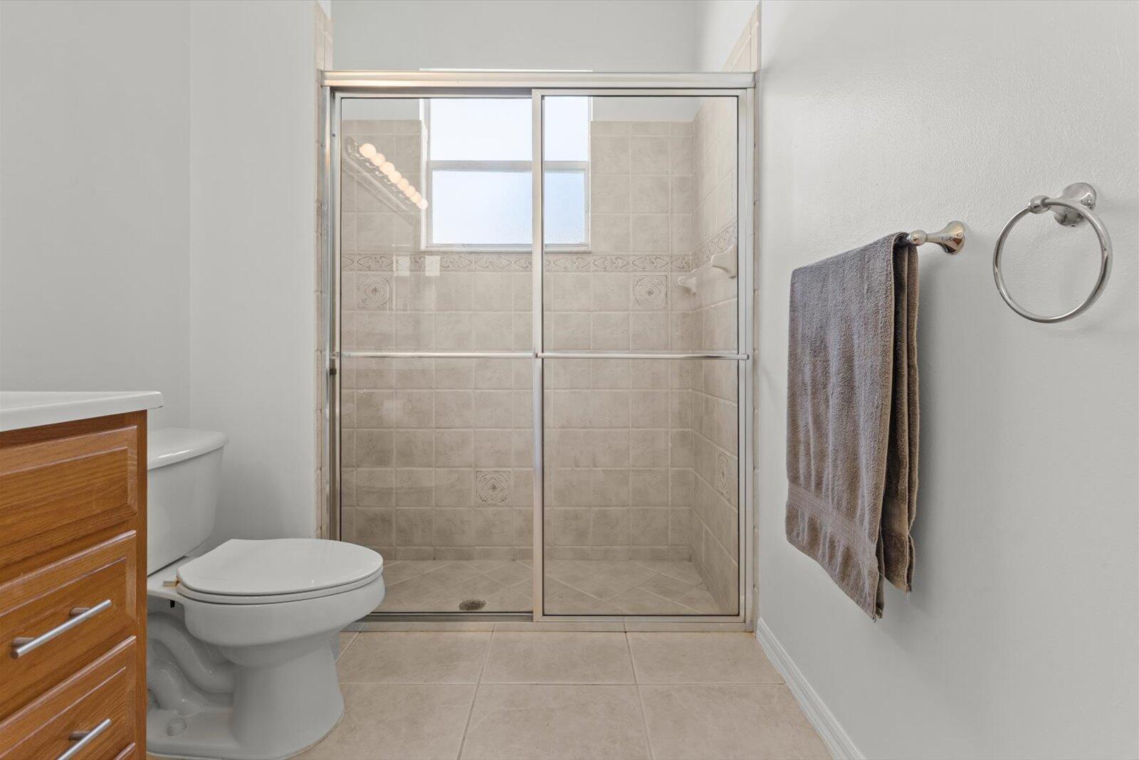 311 Southwest Coconut Key Way Port St. Lucie, FL 34986 - Photo 20 of 25 a bathroom with a toilet and a shower
